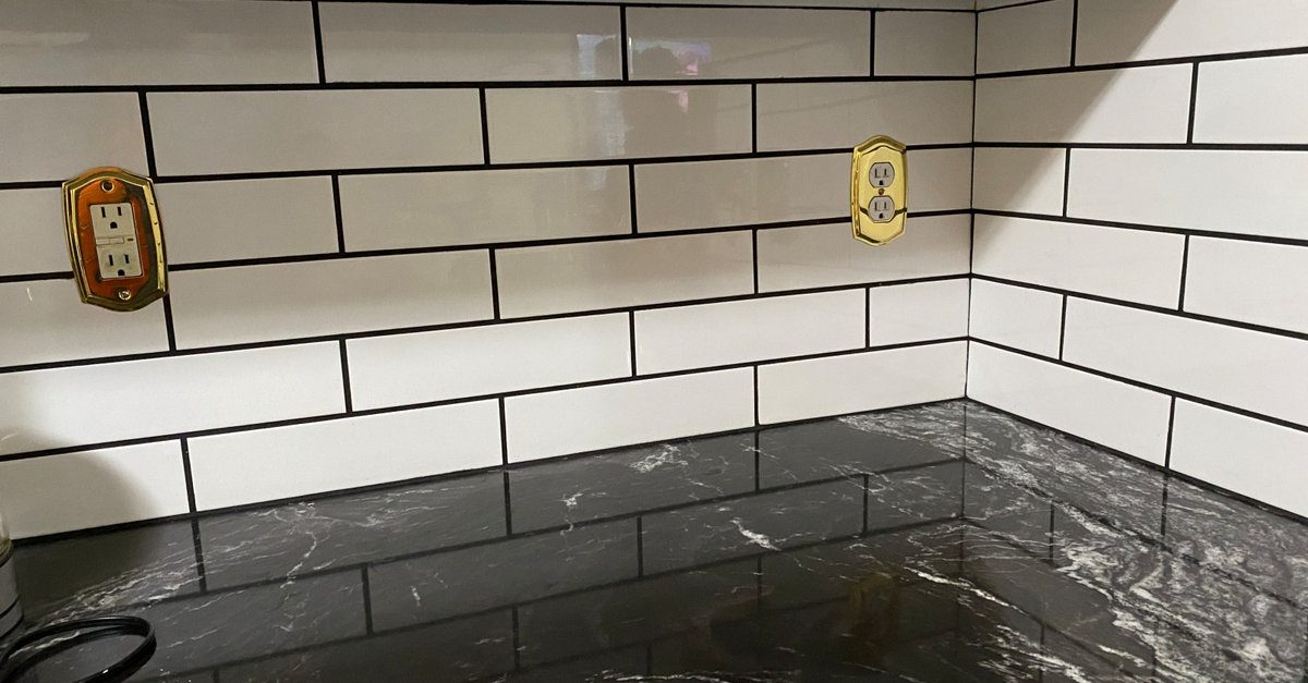 Subway tile backsplash with dark granite countertop installed by AFGH Handyman during a kitchen remodel